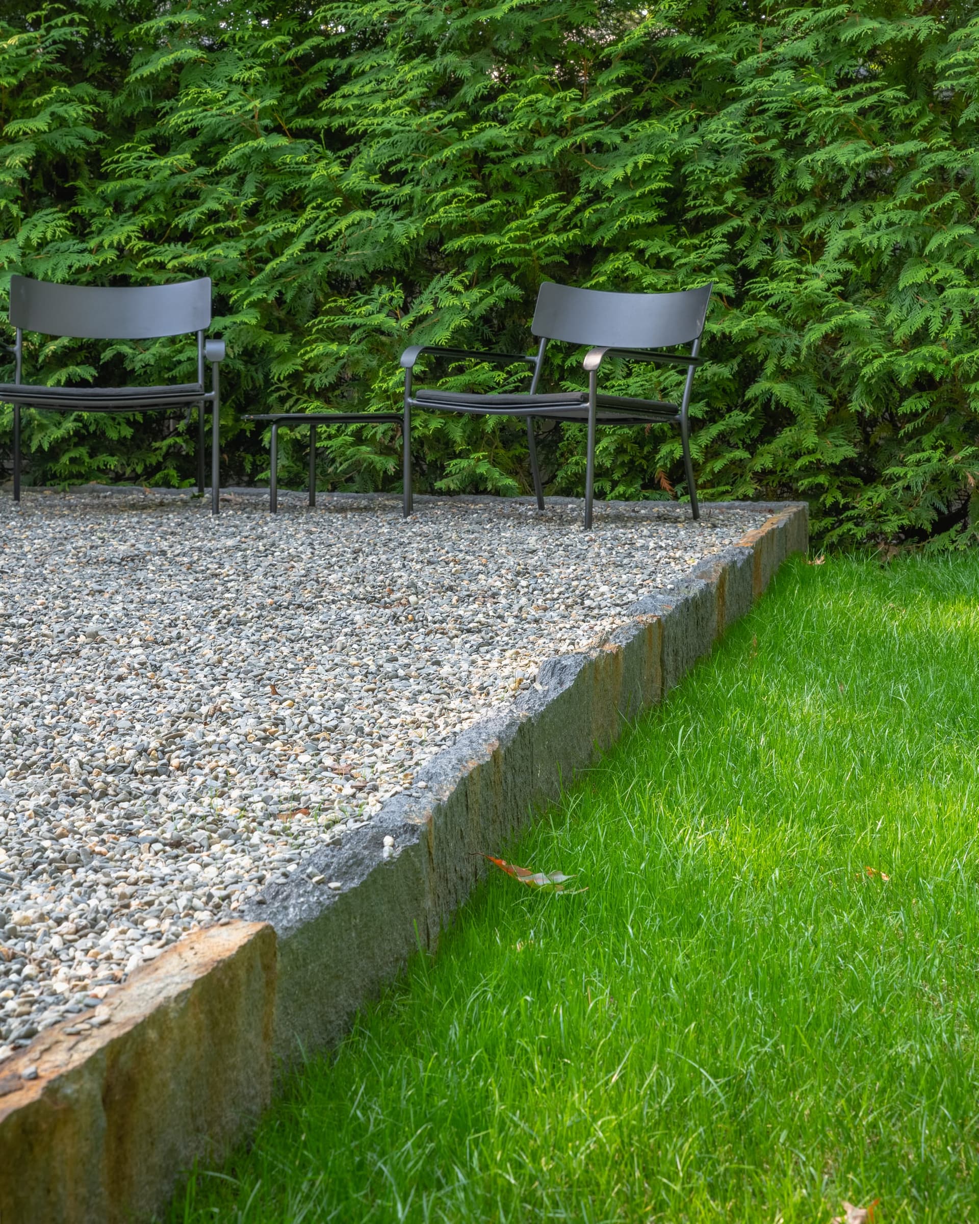 Circuit Road — granite edge holding the pea-stone terrace against the lawn in Chestnut Hill, MA