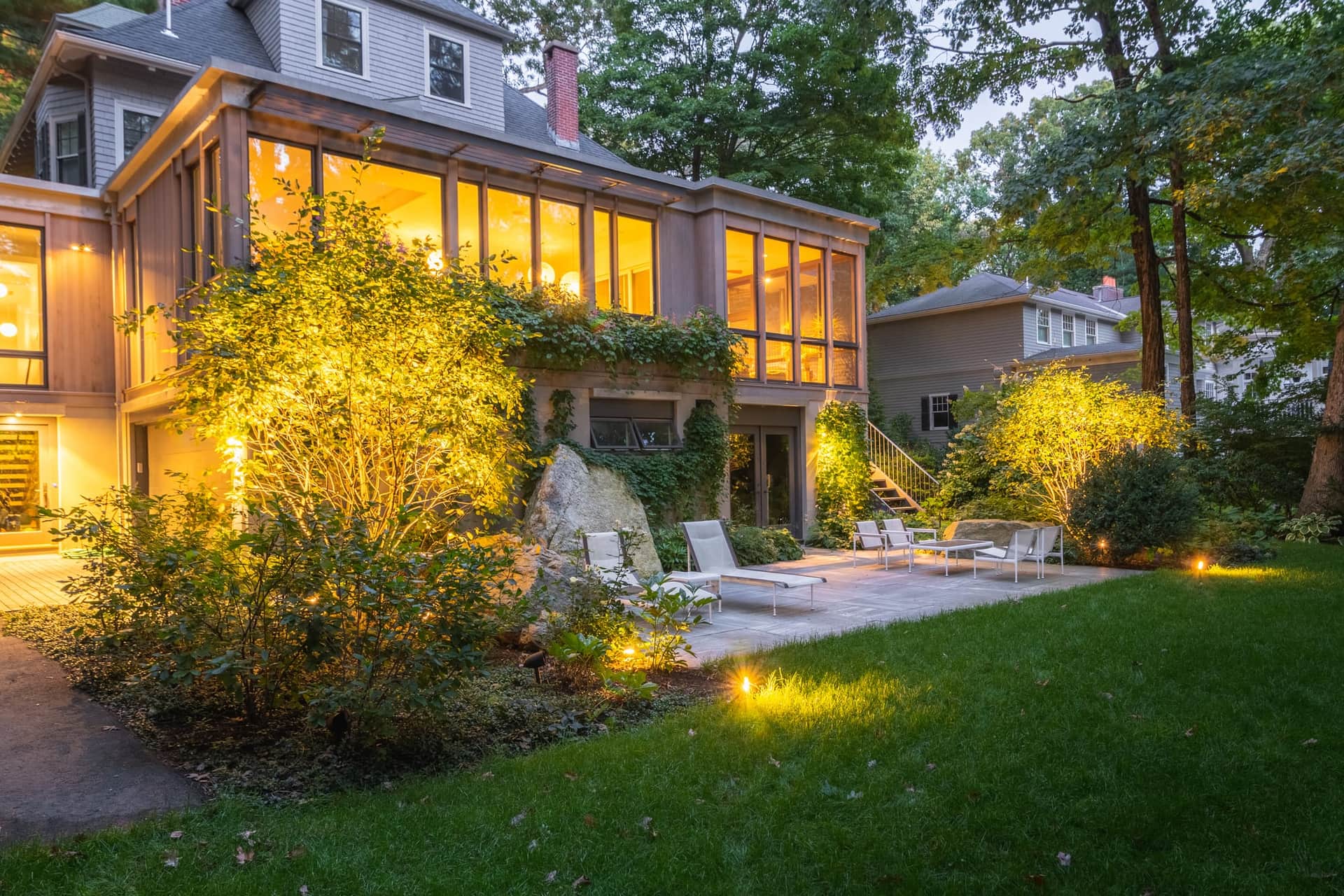 Abbott Road — terrace and fieldstone walls lit at dusk in Wellesley, MA