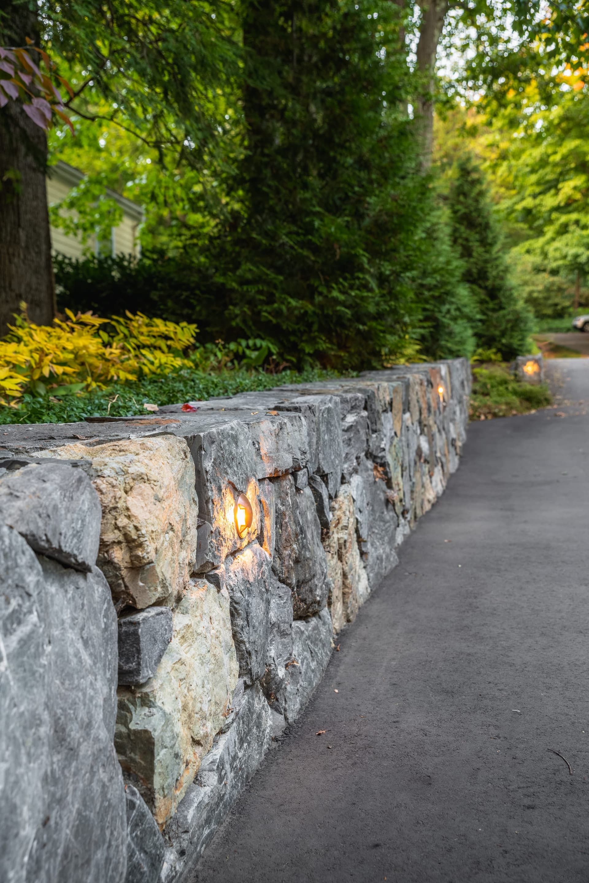 Abbott Road — fieldstone retaining wall with recessed lighting along the drive in Wellesley, MA