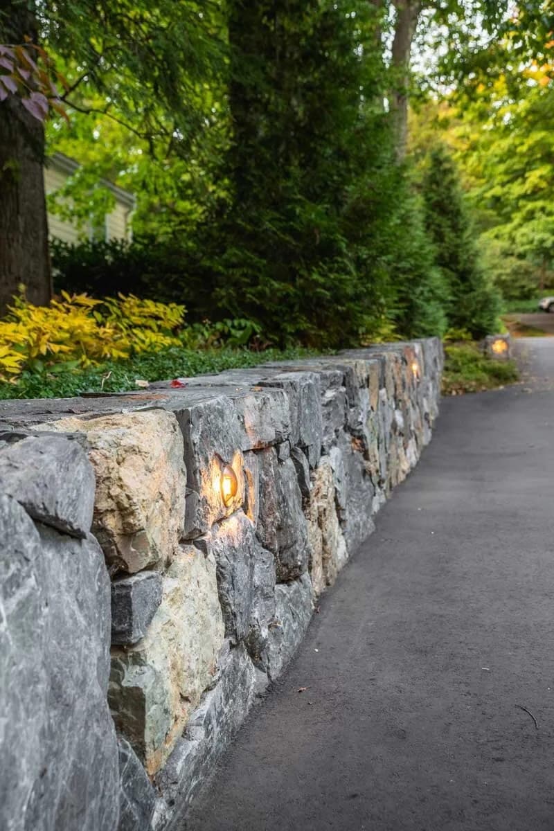 Dry-stacked fieldstone wall along a drive in Wellesley, MA