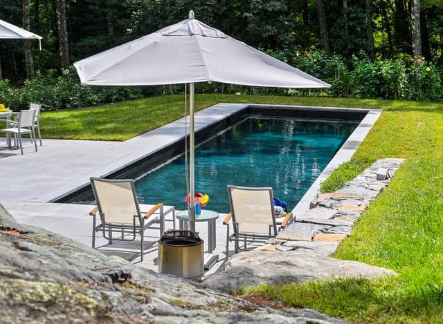 Pool terrace with lounge seating and stone surround