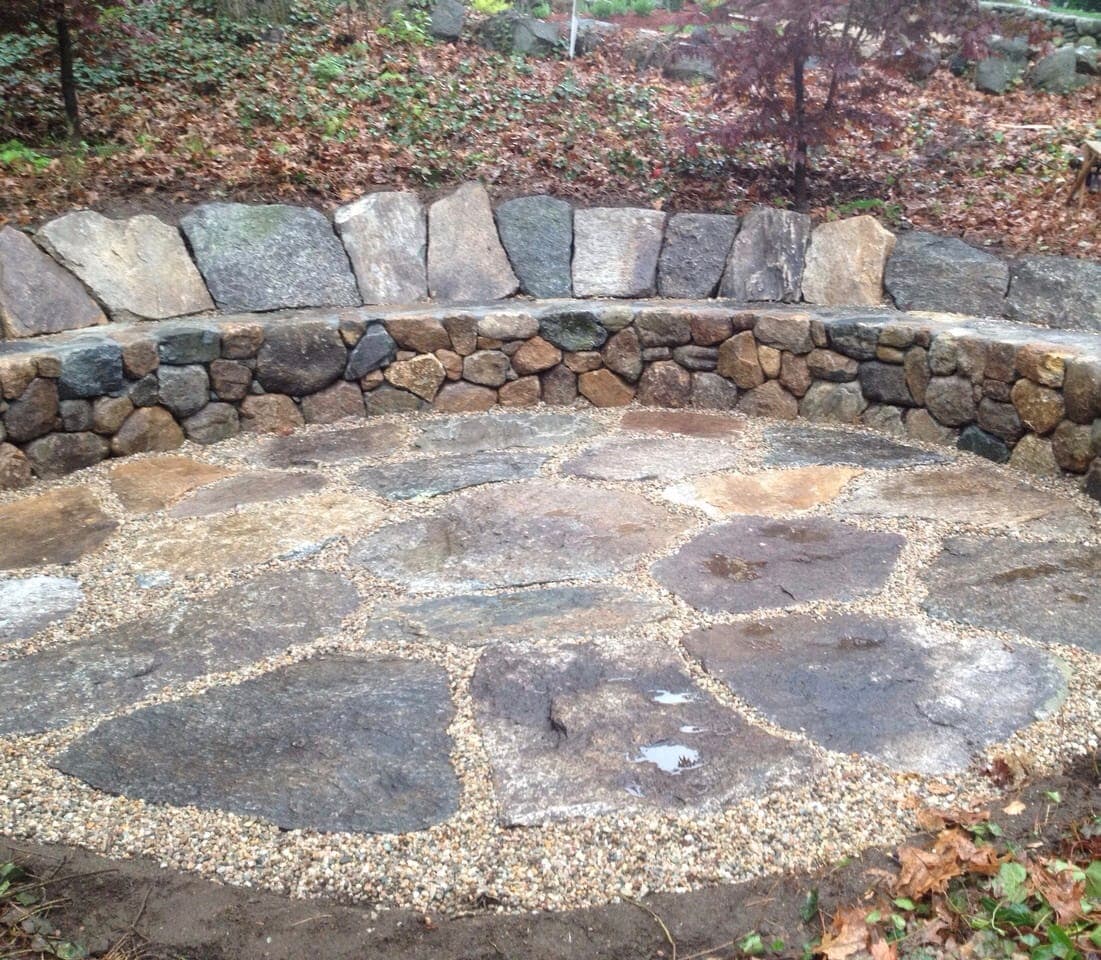 Bluestone patio with fieldstone wall in Lexington, MA