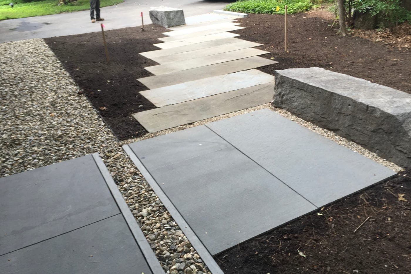 Natural stone walkway leading to a home entrance in Lincoln, MA