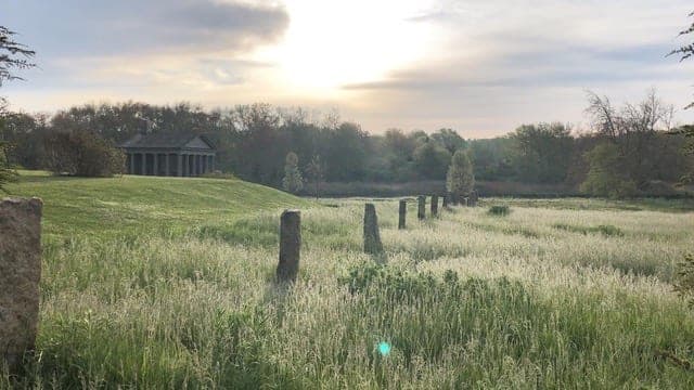 Granite Terraces — granite posts standing in the meadow at sunrise in Westport, MA